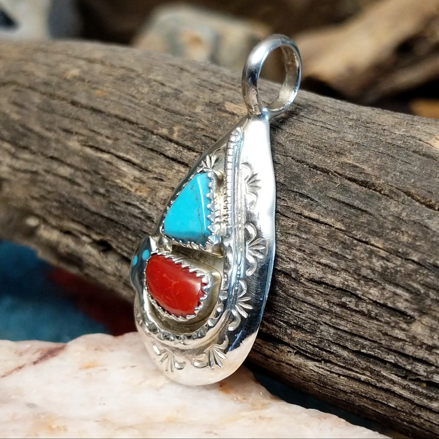 Sterling silver pendant with turquoise and coral set in the bezel, stamped setting and snake design.