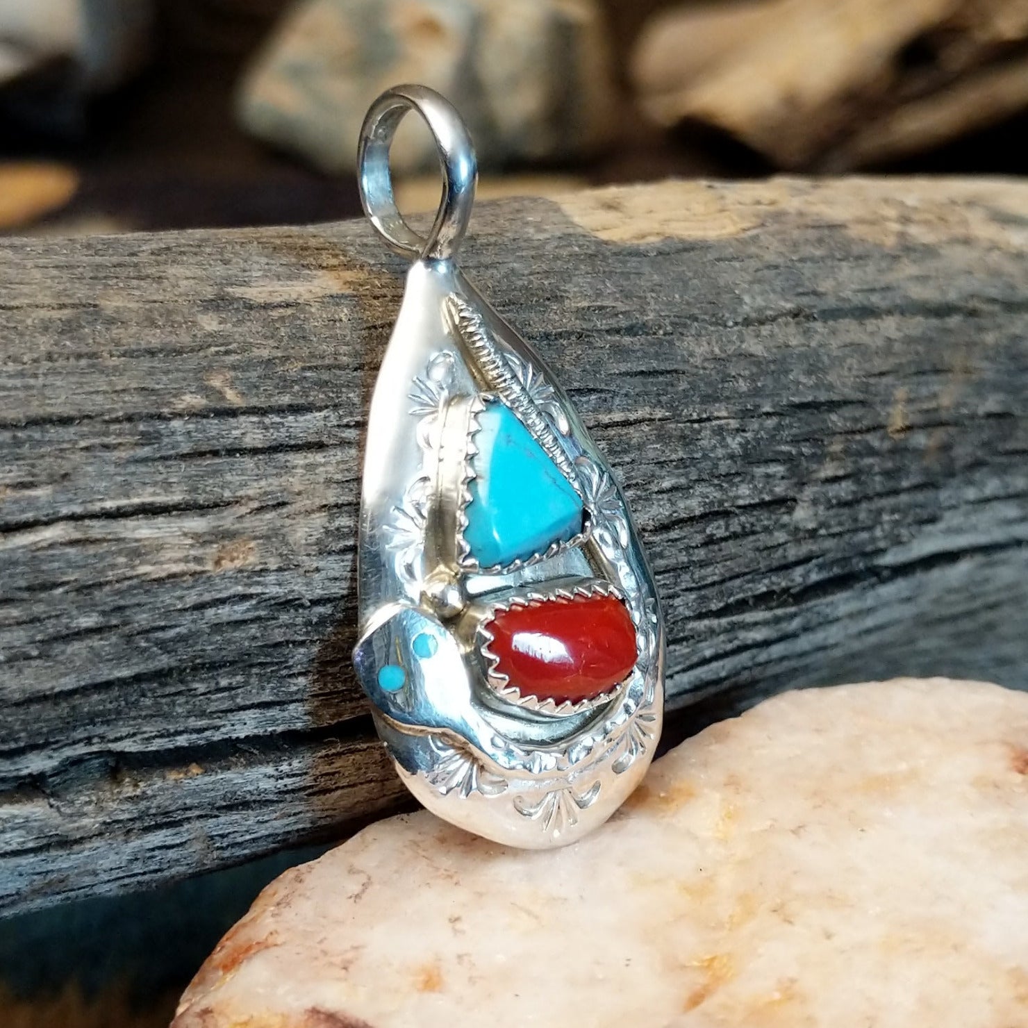 Sterling silver pendant with turquoise and coral set in the bezel, stamped setting and snake design.