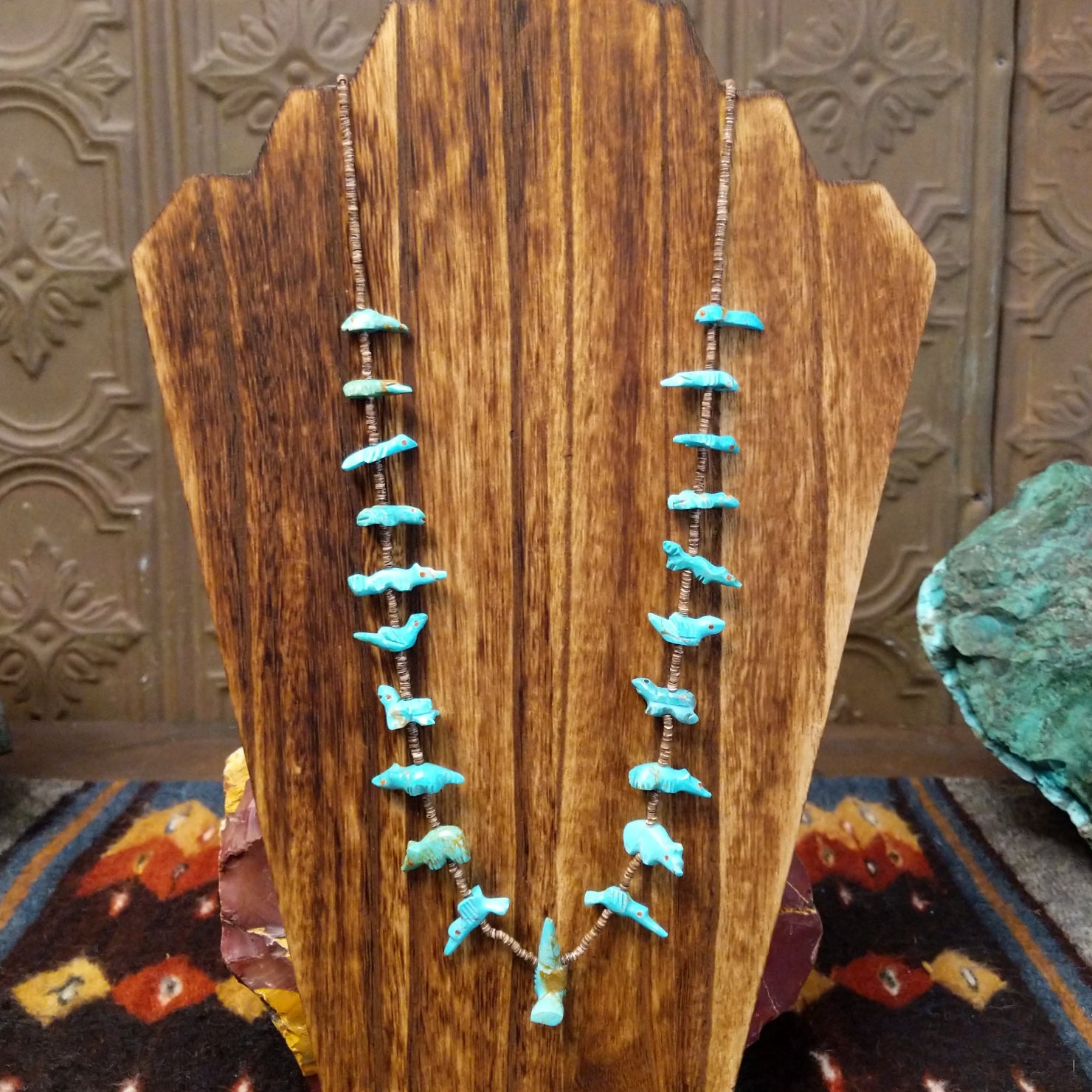 Necklace displays Zuni turquoise fetish carvings of various animals with heishi beads.