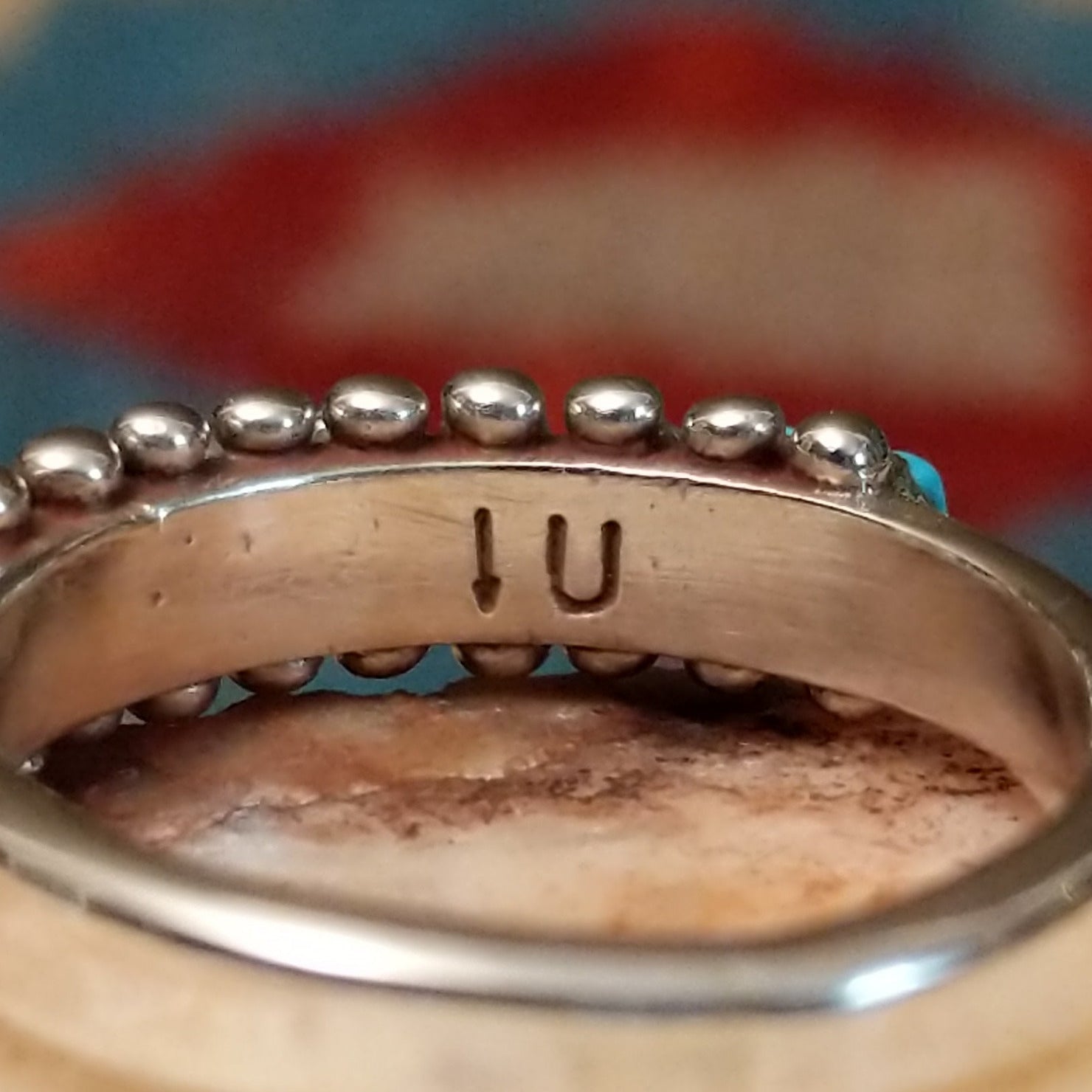 Close-up of the artisan's stamped signature.