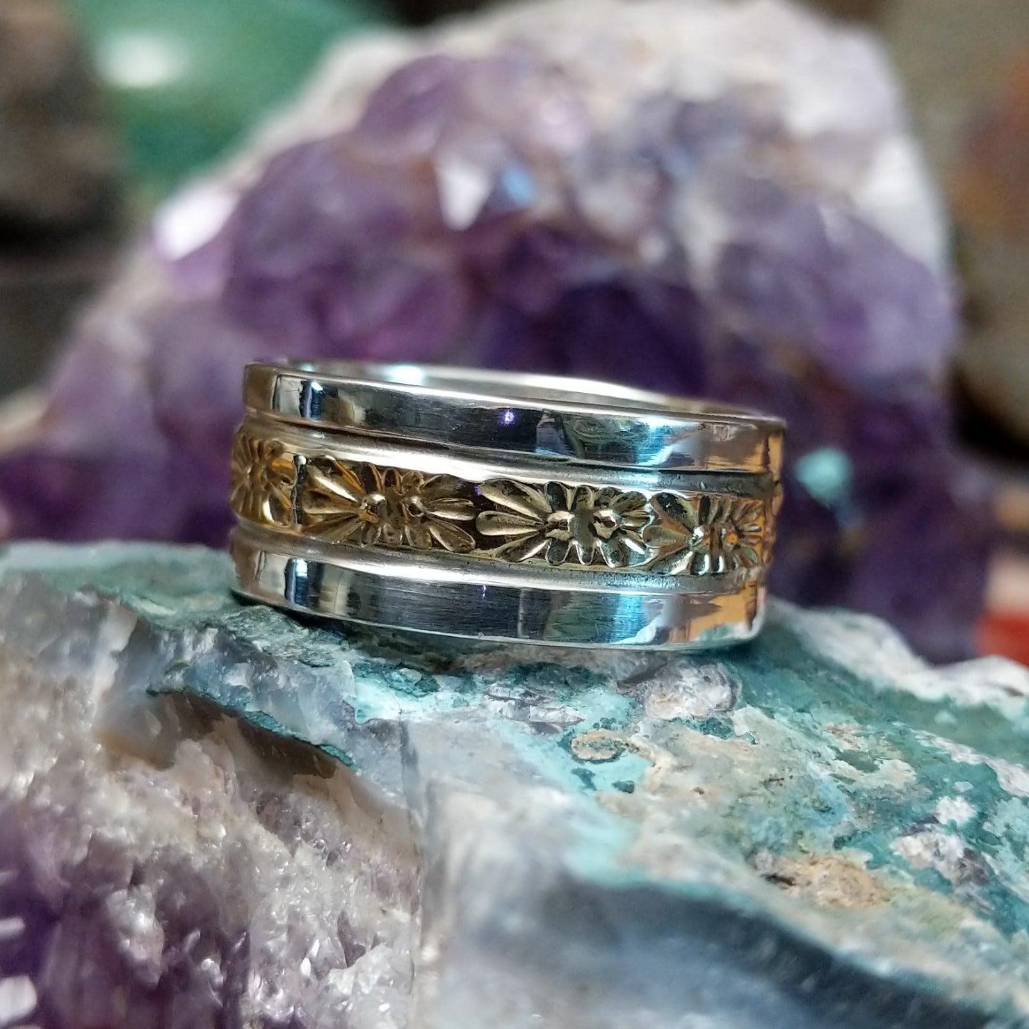 Silver and 14K gold stamped ring by Marc Antia, featuring hand-stamped geometric patterns, gold accents, and a polished sterling silver band.