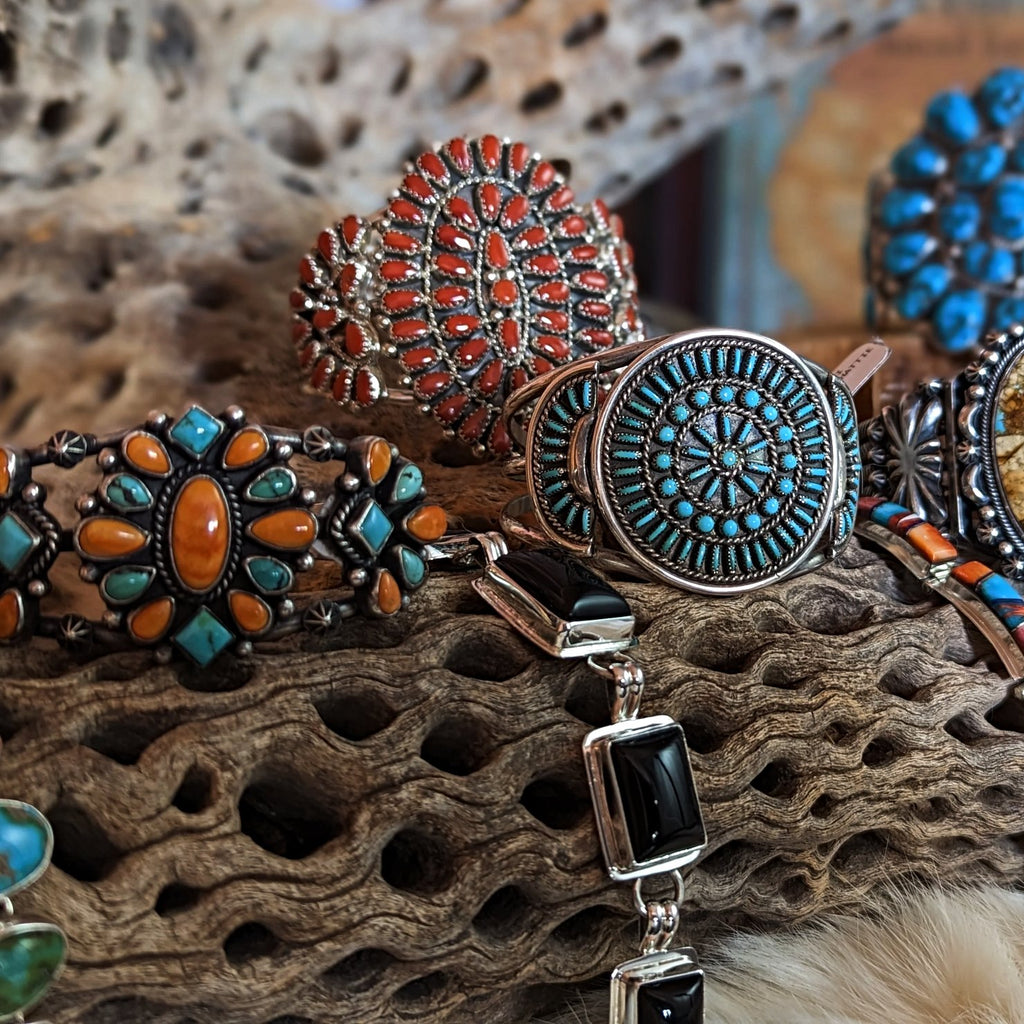 a collection of native american made bracelets