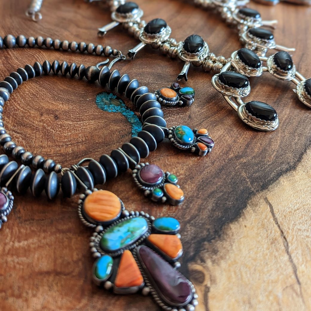 selection of native american made of sterling silver with of various turquoise, coral and other stones 