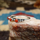 Sterling silver ring with coral set in three small, round bezels.