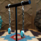 Sterling silver dangle earrings with Kingman turquoise set in the oval bezels.