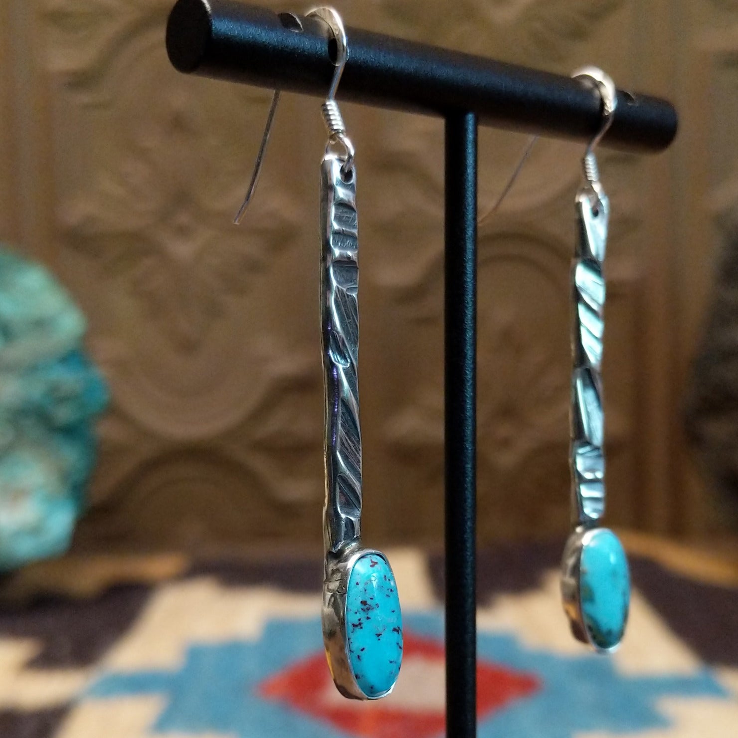 Sterling silver dangle earrings with Kingman turquoise set in the oval bezels.