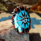 Sterling silver ring with multistone inlay creating a sunface motif.