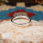 Sterling silver ring with coral set in three small, round bezels.