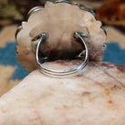 Sterling silver ring with multistone inlay creating a sunface motif.