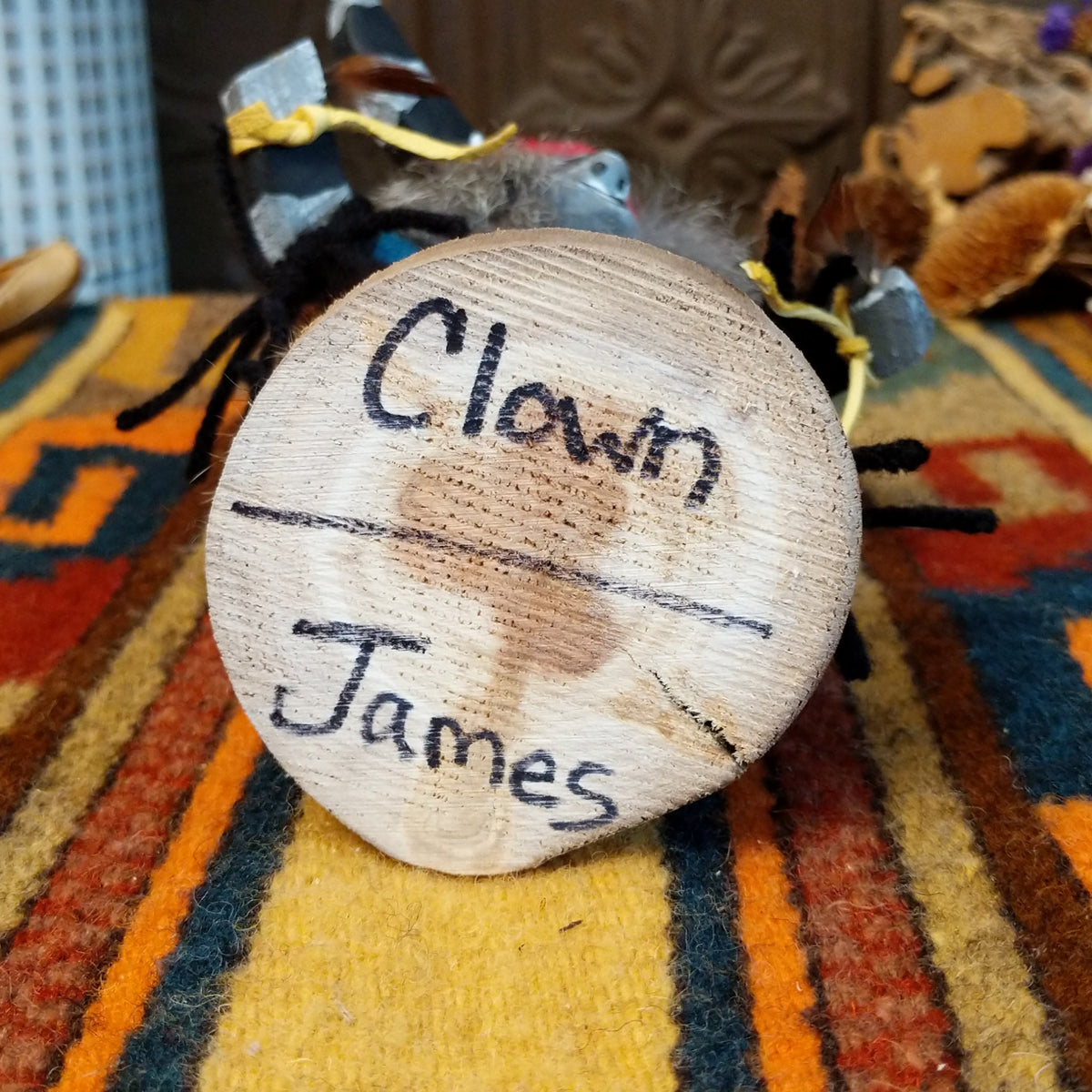 Underside of Navajo Clown Kachina doll base with handwritten figure name and artist surname.