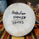 Underside of Navajo Protection Dancer Kachina doll base with handwritten figure name and artist surname.