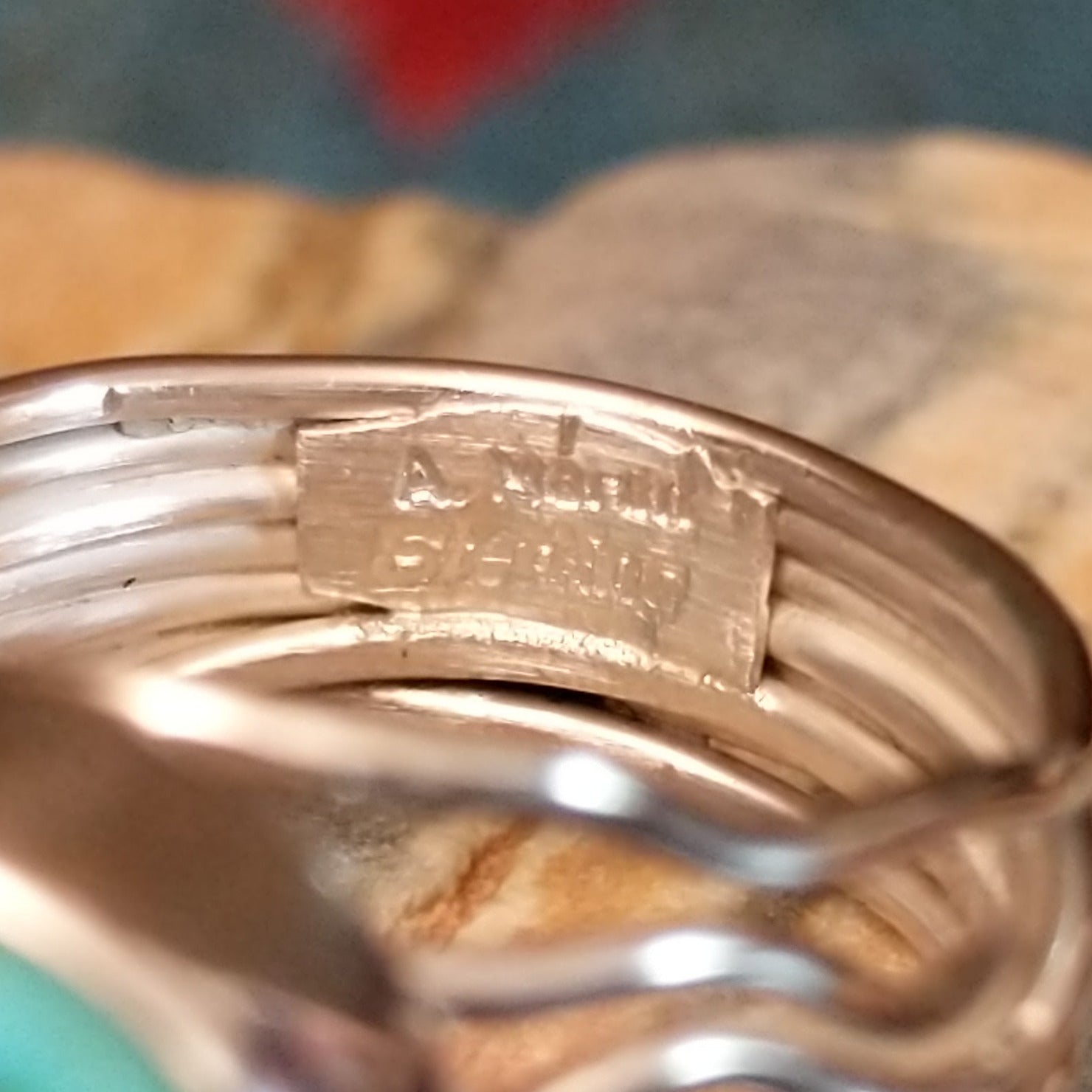 Close-up of the artisan's stamped signature.