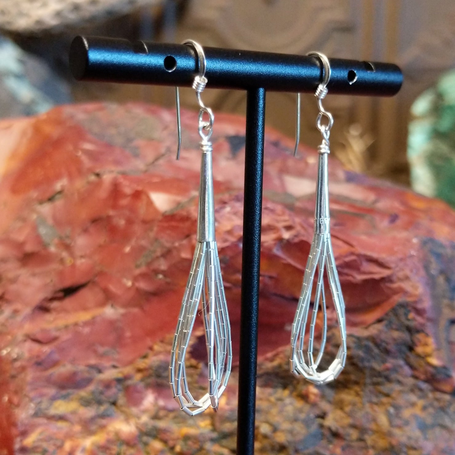 Five strands of sterling silver beaded together to create the earrings.