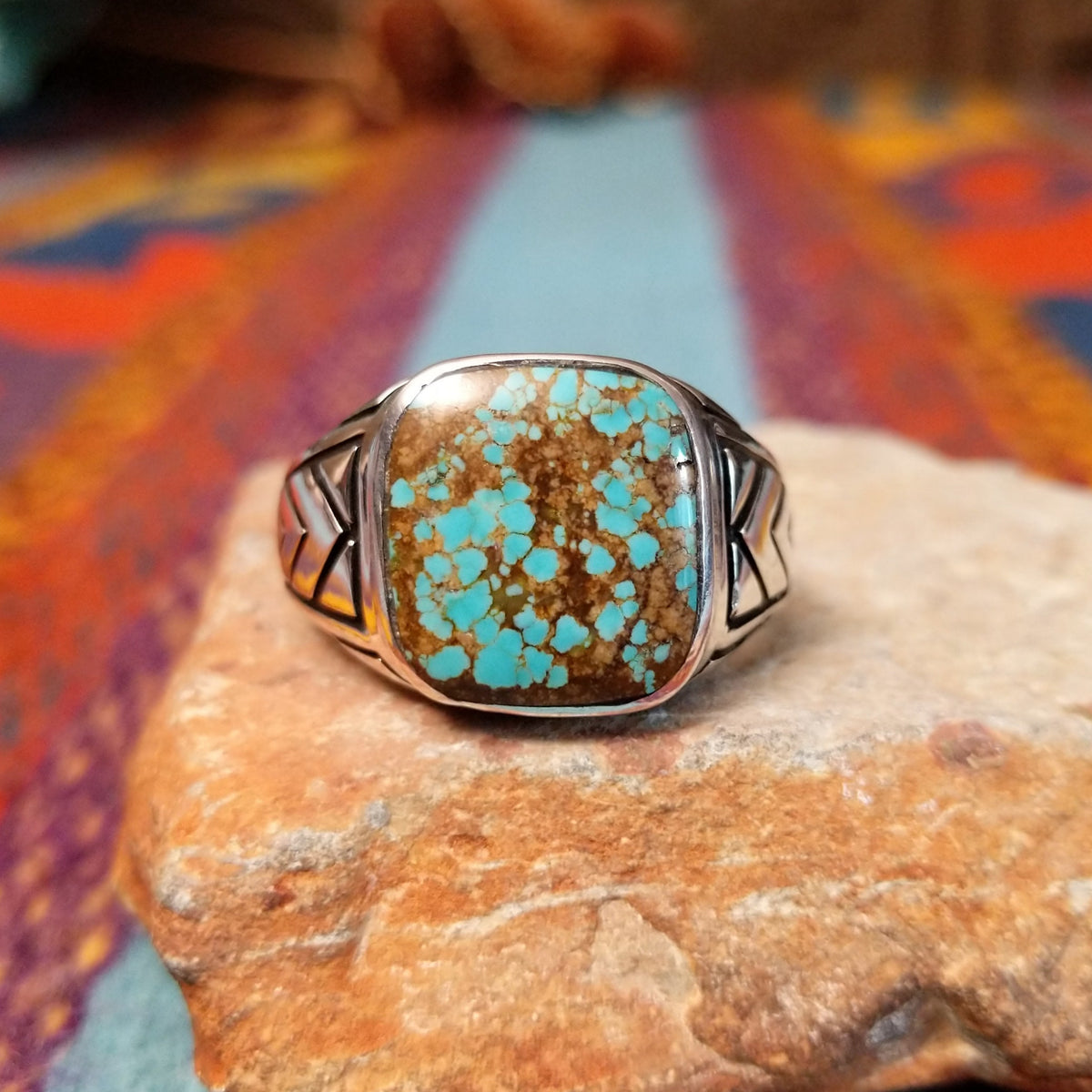 #8 Turquoise Ring by Terry Wood featuring a square turquoise stone with prominent natural brown matrix, set in Sterling Silver with geometric openwork detailing along the band.