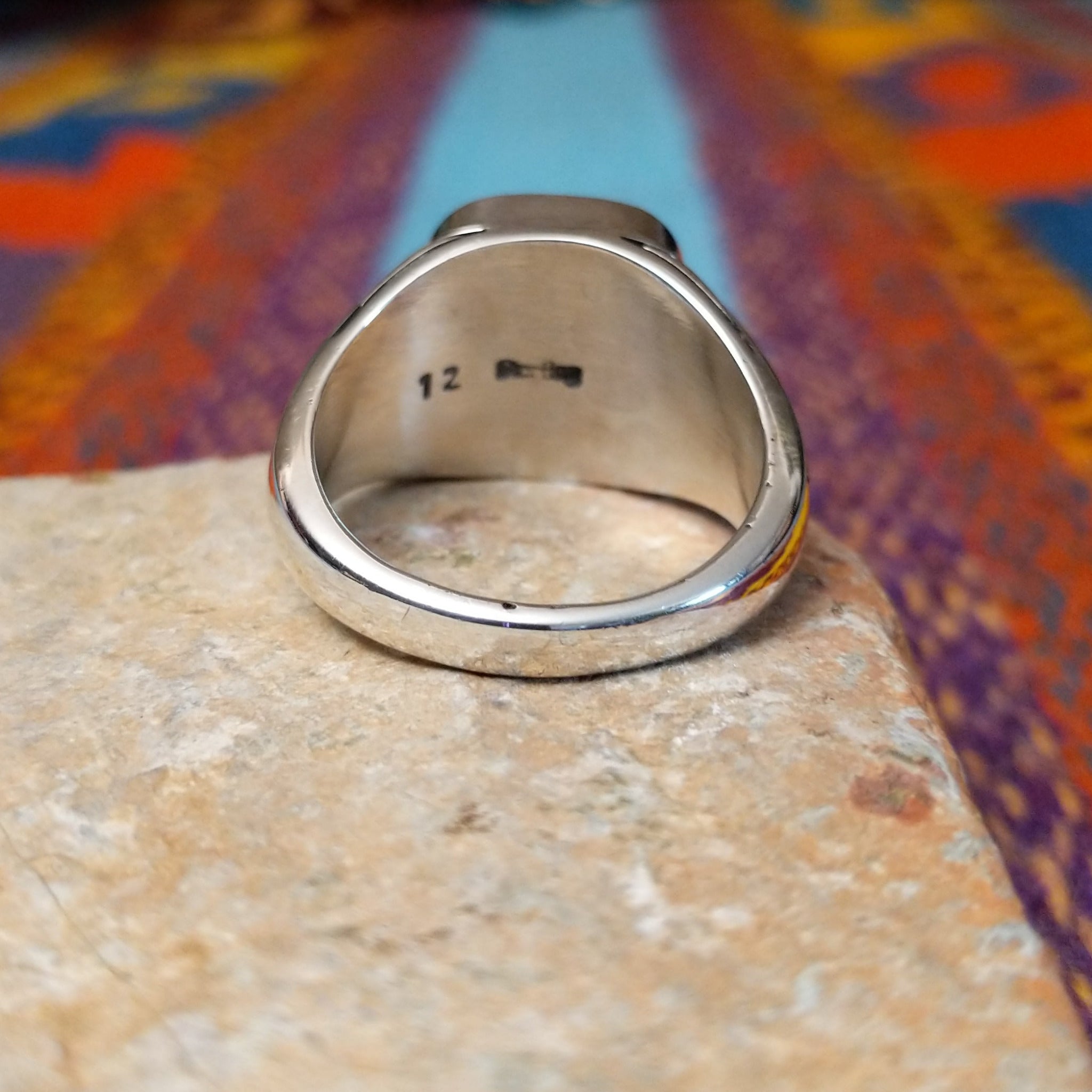 #8 Turquoise Ring by Terry Wood featuring a square turquoise stone with prominent natural brown matrix, set in Sterling Silver with geometric openwork detailing along the band; underside view.