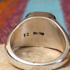 #8 Turquoise Ring by Terry Wood featuring a square turquoise stone with prominent natural brown matrix, set in Sterling Silver with geometric openwork detailing along the band; Sterling Silver stamp.