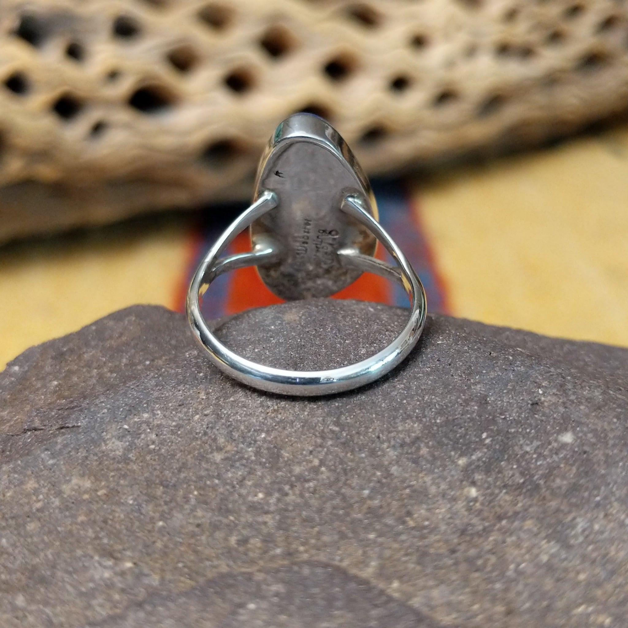 Abstract lapis ring by Cathy Webster, featuring a deep blue lapis stone with natural pyrite flecks set in a handcrafted sterling silver contemporary design.  Underside view.