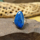 Abstract lapis ring by Cathy Webster, featuring a deep blue lapis stone with natural pyrite flecks set in a handcrafted sterling silver contemporary design.