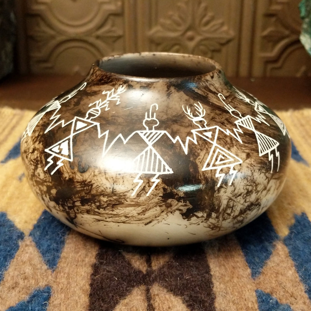 Etched friendship dancers on the white clay surface with horsehair fired onto the body, making striking contrast.