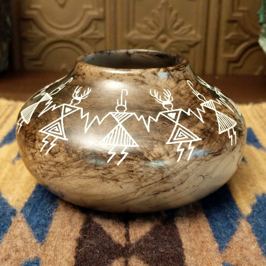 Etched friendship dancers on the white clay surface with horsehair fired onto the body, making striking contrast.