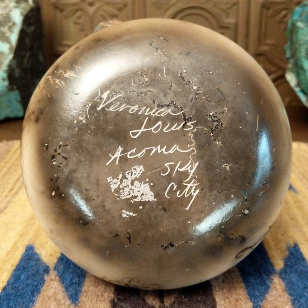 The artisan's etched signature found at the base of pottery.