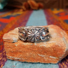 Adorned Silver Ring by Bobby Platero with central stamped rosette and layered silverwork.