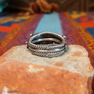 Adorned Silver Ring by Bobby Platero with central stamped rosette and layered silverwork.
