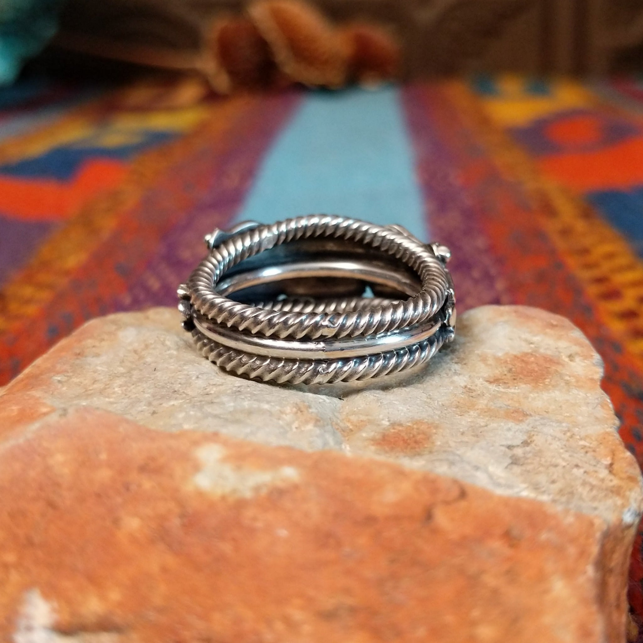 Adorned Silver Ring by Bobby Platero with central stamped rosette and layered silverwork.