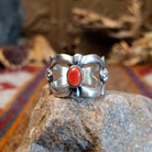 Sterling silver ring with coral centerpiece set in the bezel and open concept design of the band.