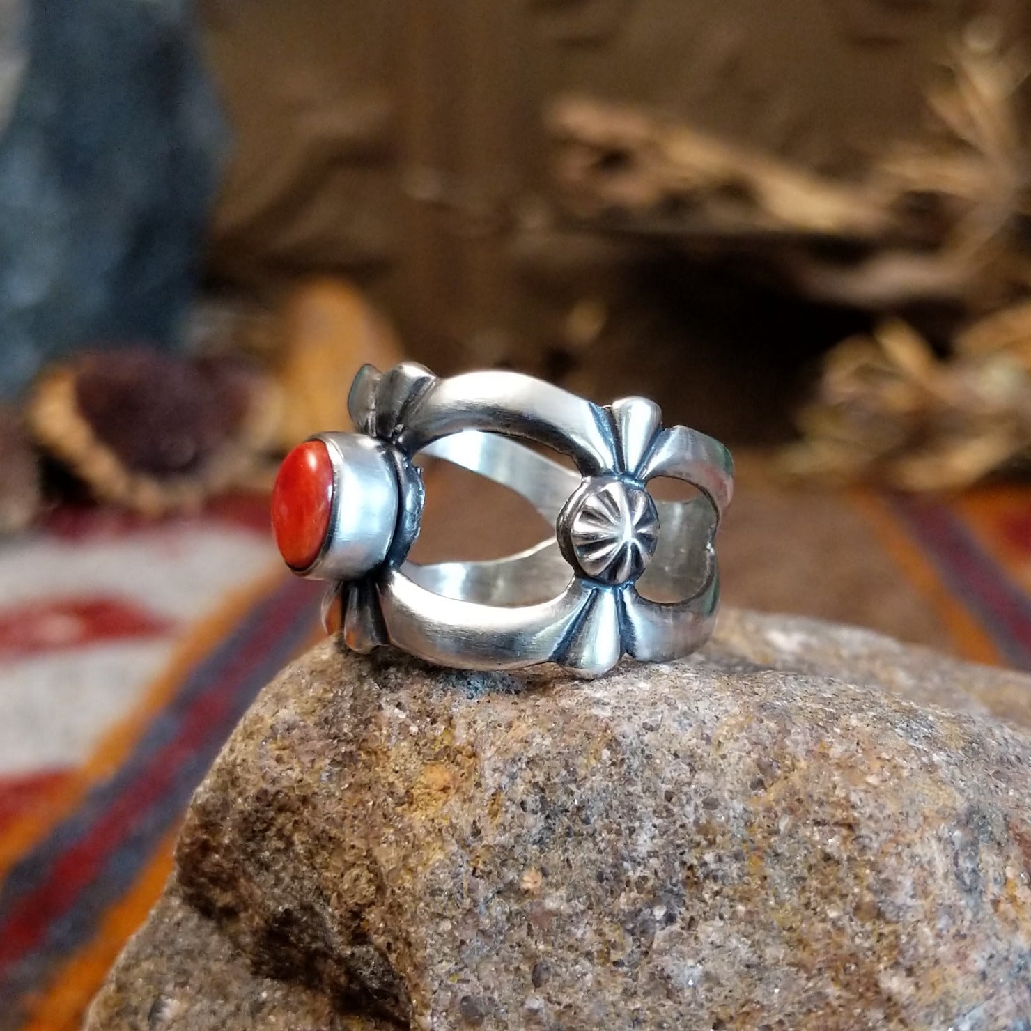 Sterling silver ring with coral centerpiece set in the bezel and open concept design of the band.