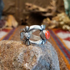 Sterling silver ring with coral centerpiece set in the bezel and open concept design of the band.