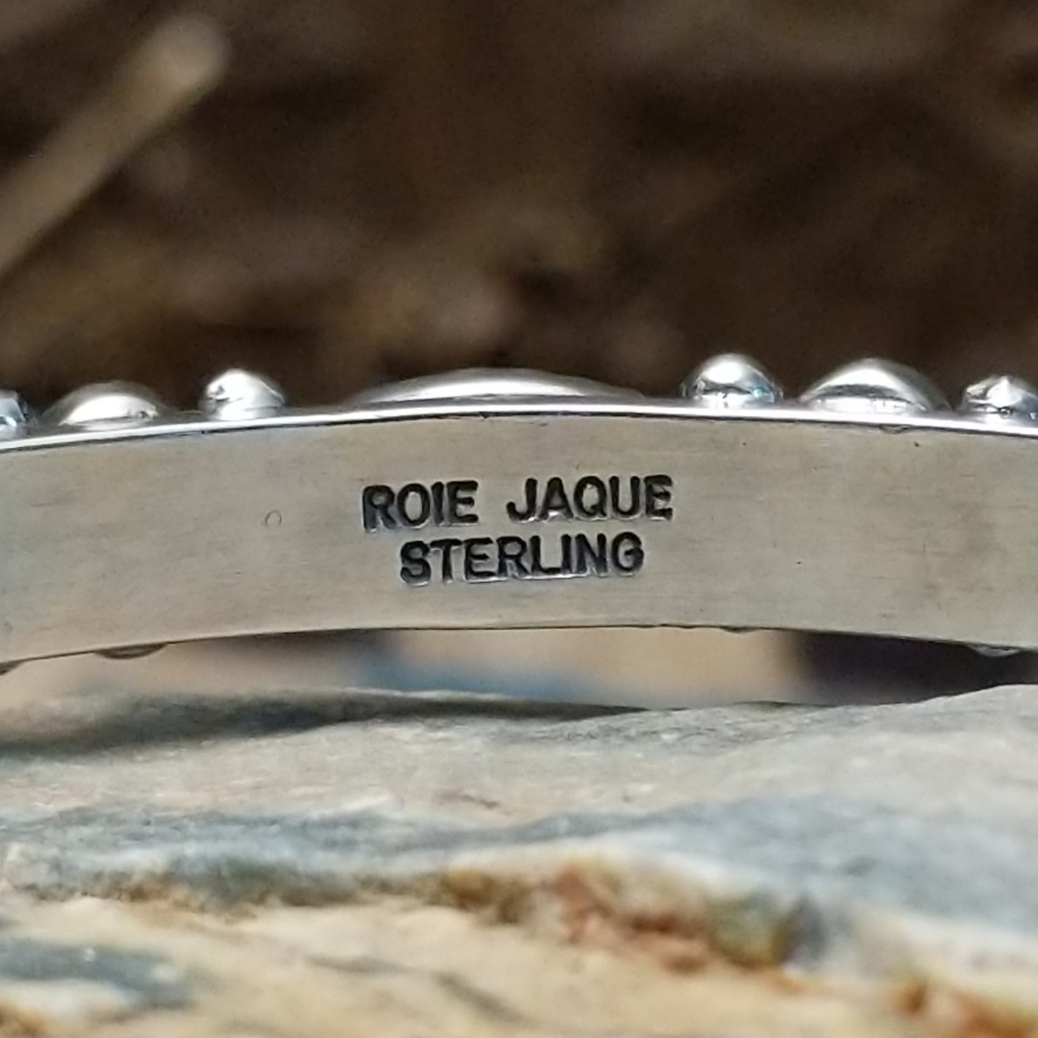 Close-up of the artisan's stamped signature.