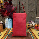 Americana Club Bag by Bamboo Trading featuring a sparkling American flag design with red and cream beaded stripes, gold stars on a textured blue background, and a coordinating red shoulder strap; back side view.