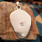 Close-up of the artisan's stamped signature.