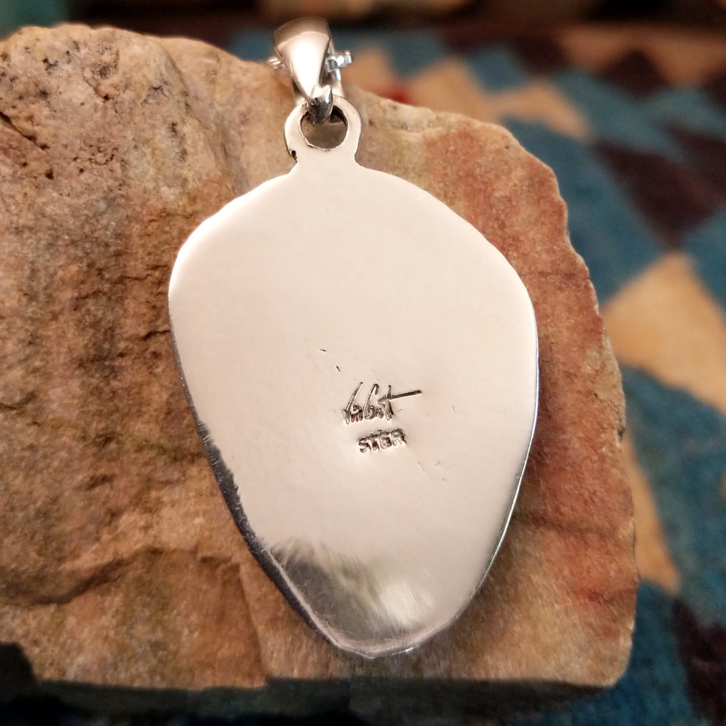 Close-up of the artisan's stamped signature.