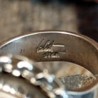 Artists signature etched on the inside of the band.
