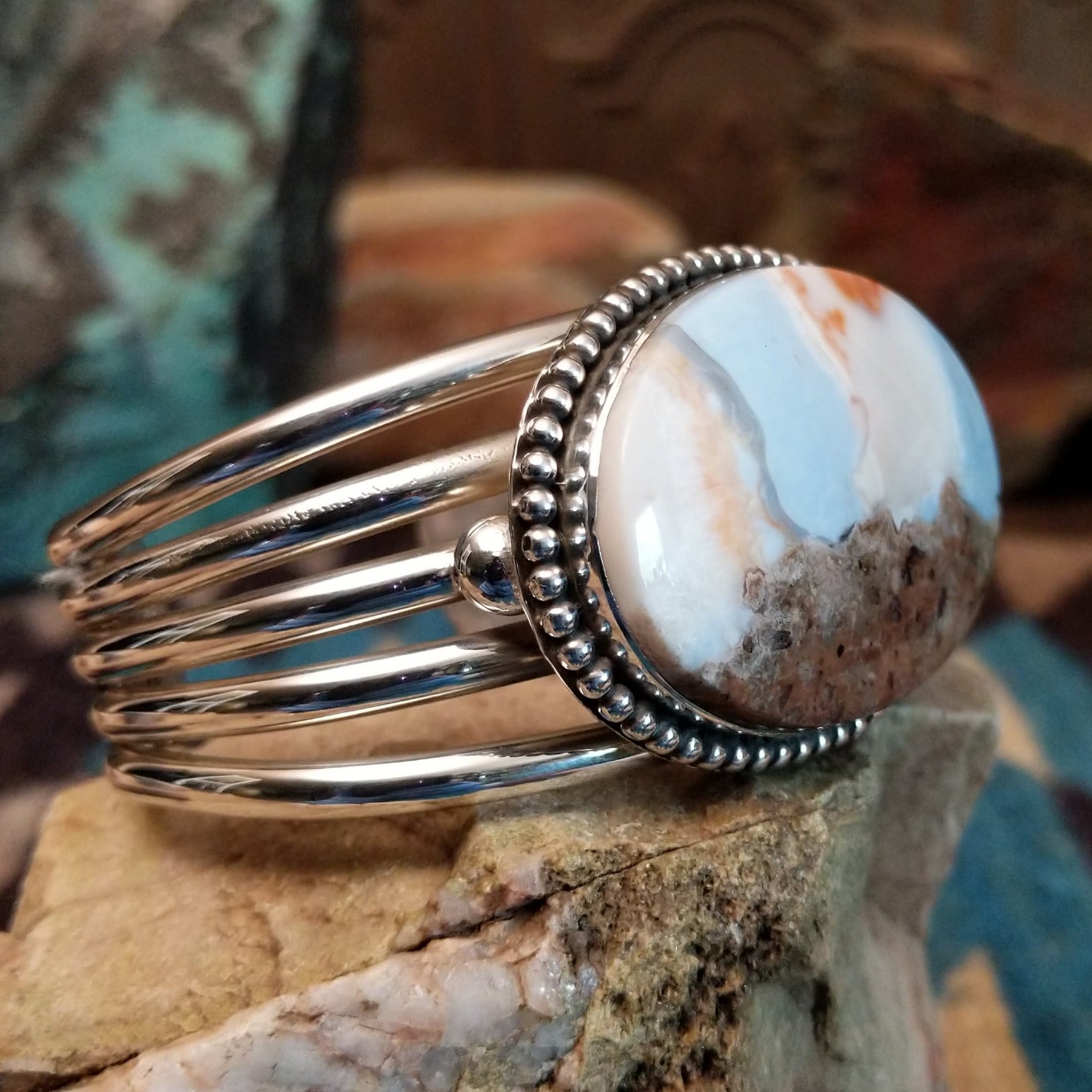 Sterling silver cuff with Arizona blue opal set in the oval bezel, framed by dotted accents.