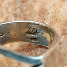 Close-up of the artisan's stamped signature.