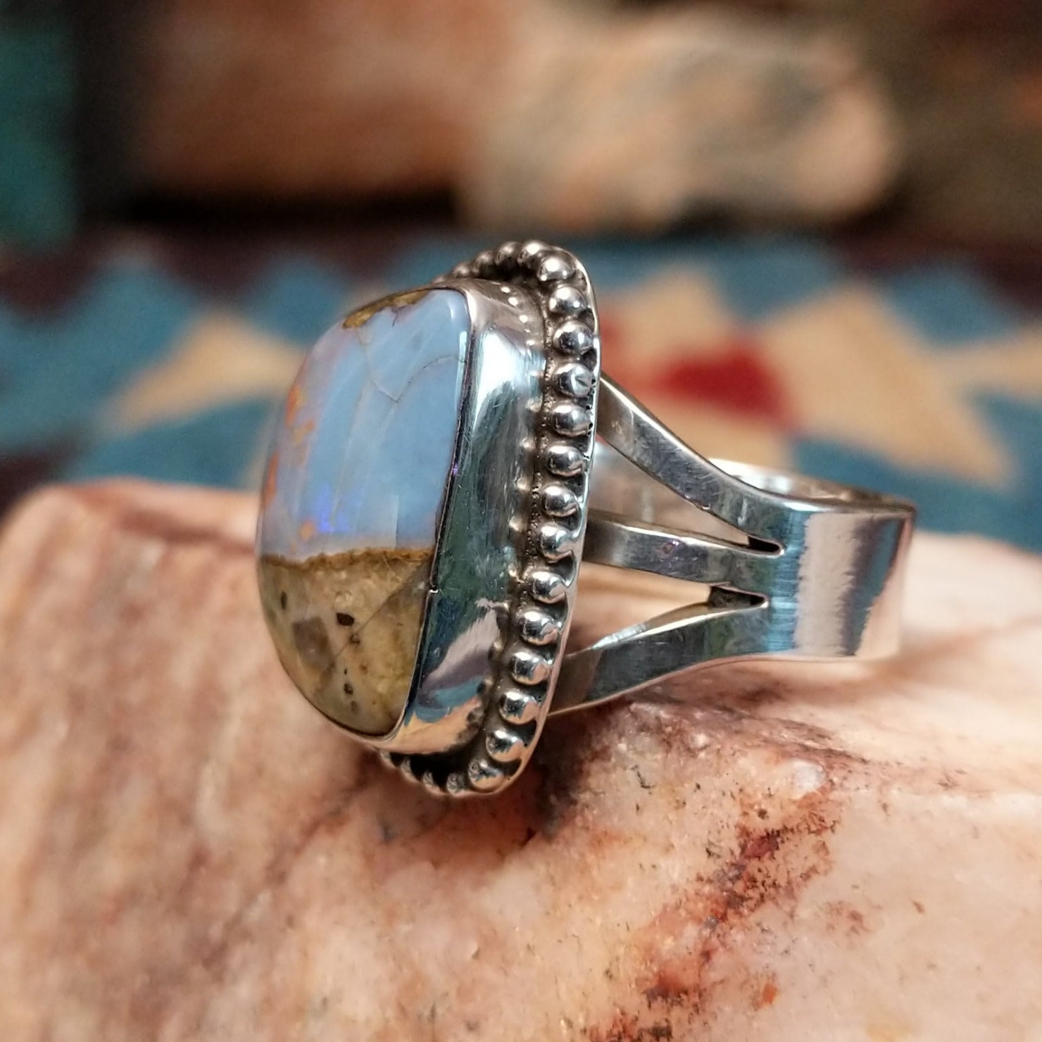 Sterling silver ring with Arizona blue opal set in the bezel, framed by dotted accents.