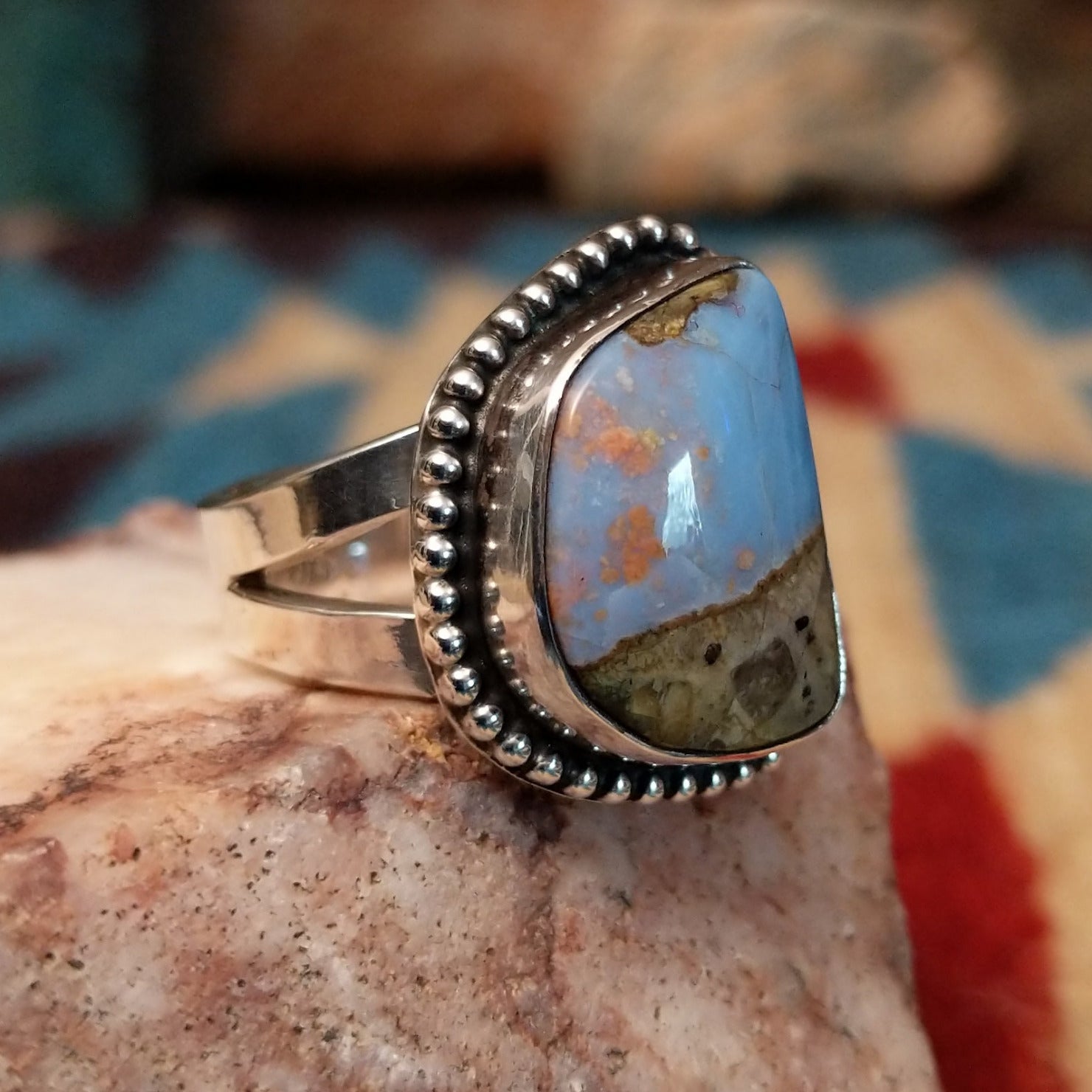 Sterling silver ring with Arizona blue opal set in the bezel, framed by dotted accents.