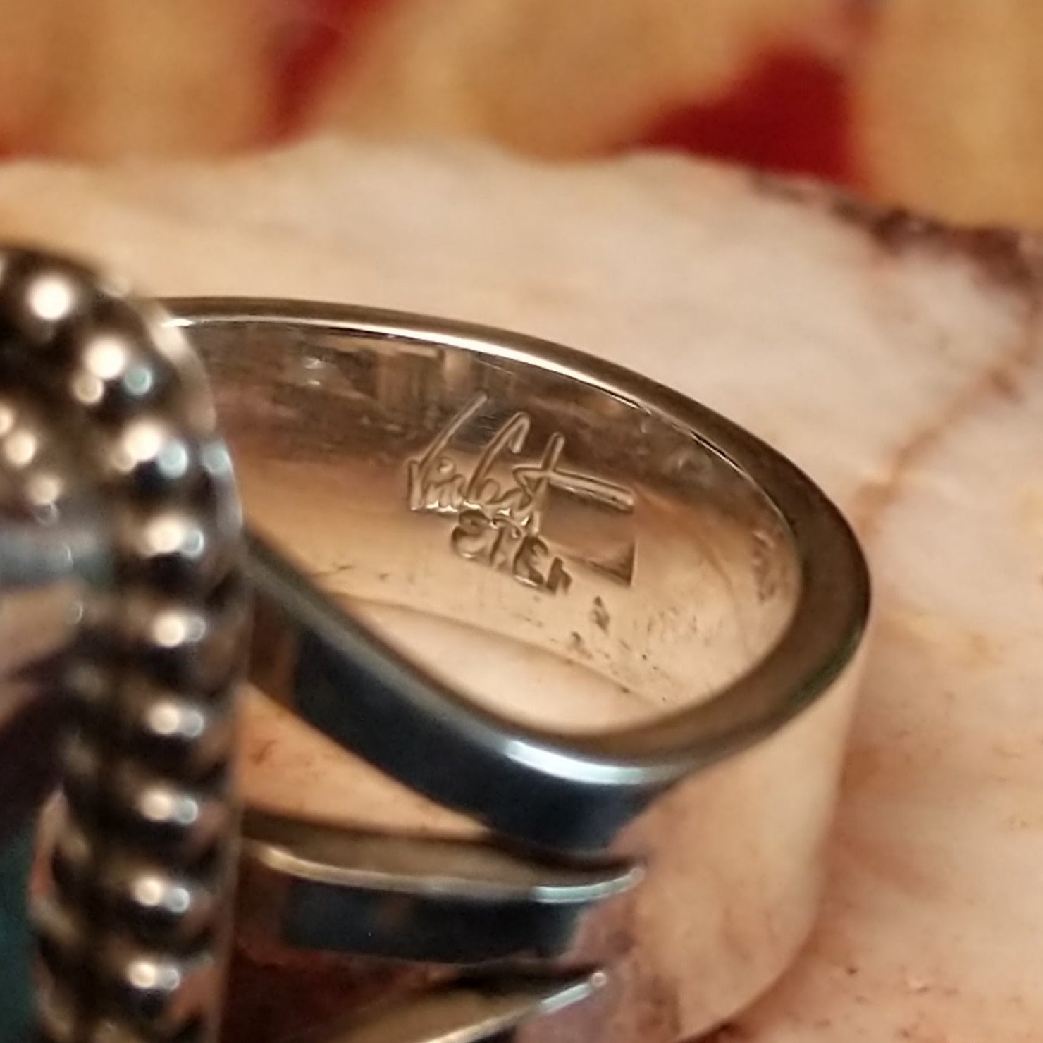 Close-up of the artisan's stamped signature.