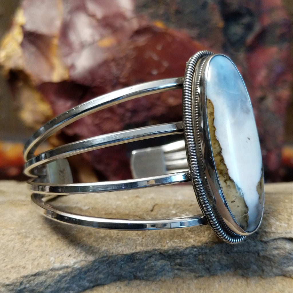 The side profile reveals a sleek sterling silver band.