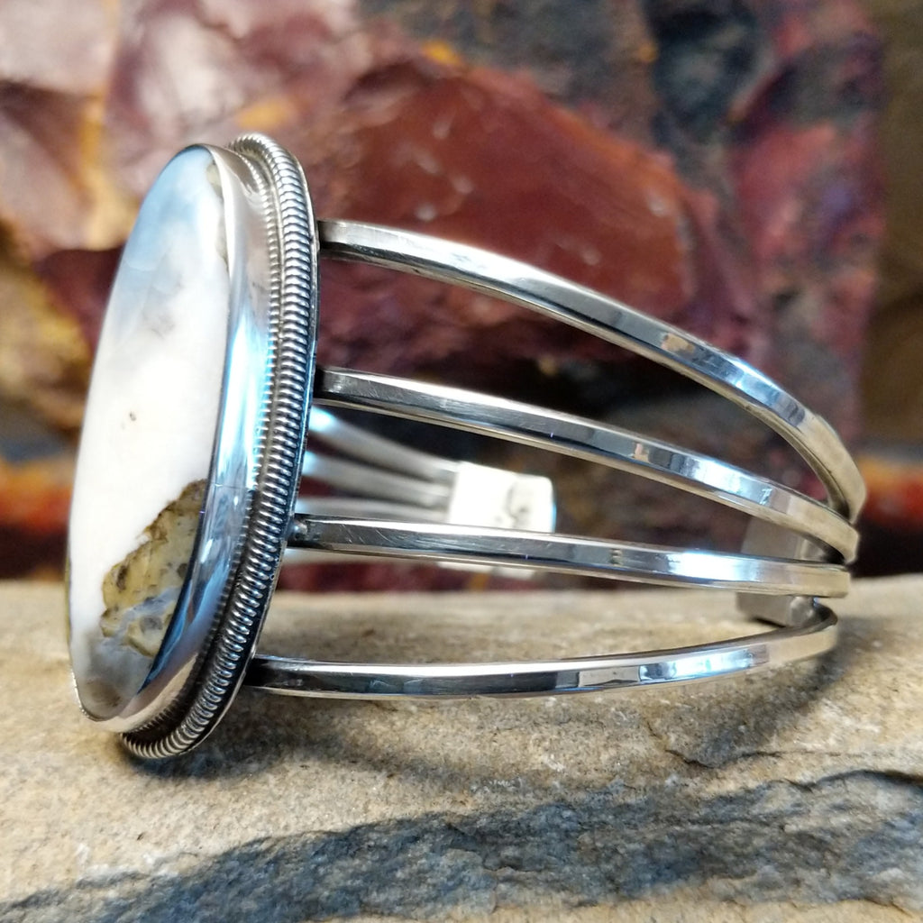 The side profile reveals a sleek sterling silver band.