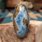Sterling silver ring with Arizona blue opal set in the large oval bezel, framed by dotted accents.