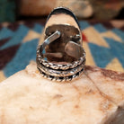 Sterling silver ring with Arizona blue opal set in the large oval bezel, framed by dotted accents.