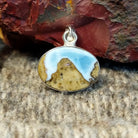 An oval Arizona Blue Opal pendant in a sterling silver setting.