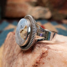 Sterling silver ring with Arizona blue opal set in the oval bezel, framed by ribbed silverwork.