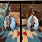 Sterling silver dangle earrings with Arizona blue opal set in oval bezels.