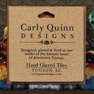 Corkboard backing of a hand-glazed ceramic tile with artist details.