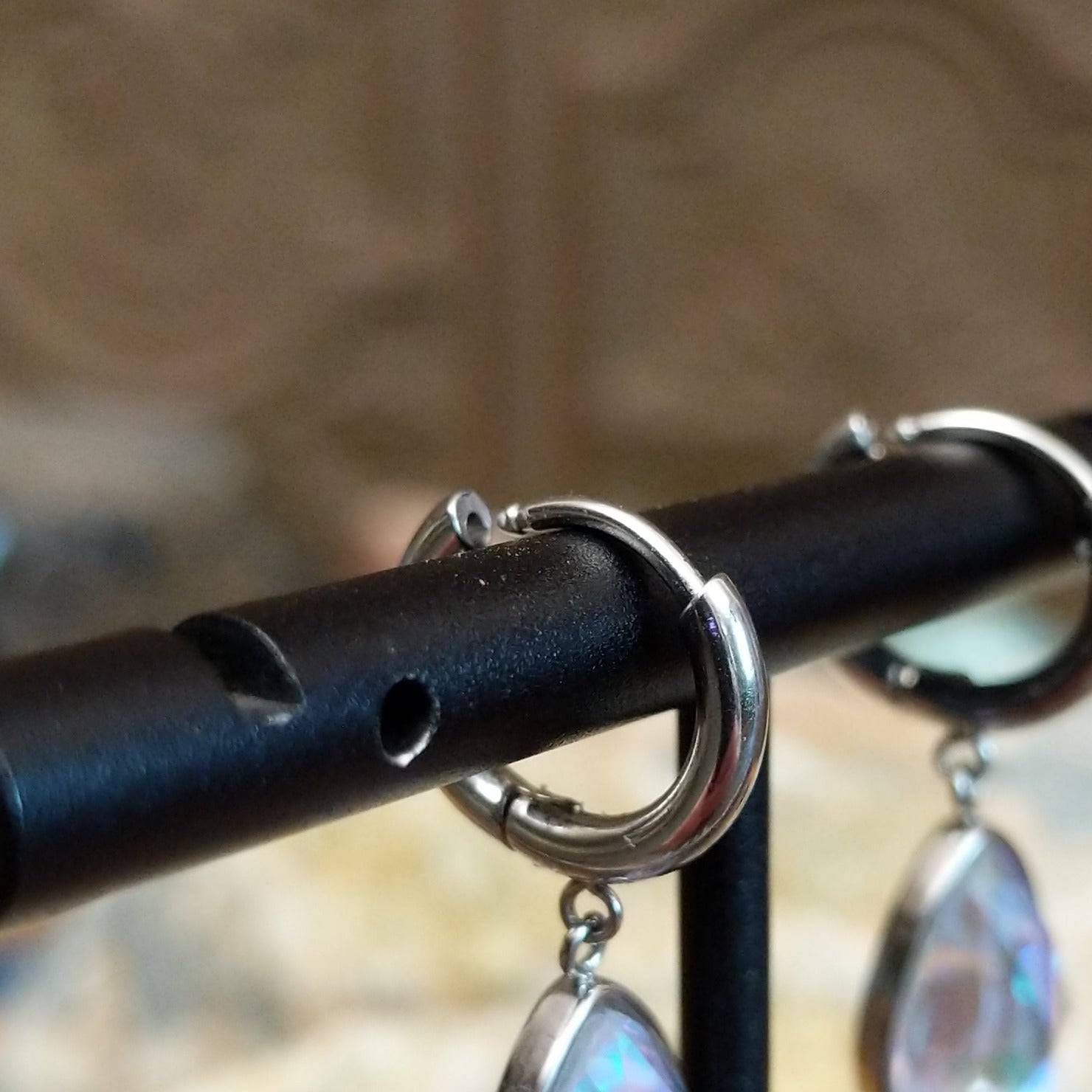 Aurora teardrop crystal earrings by LeightWorks, featuring faceted teardrop-shaped crystals with brilliant sparkle and an elegant lightweight design. Huggie back - Green